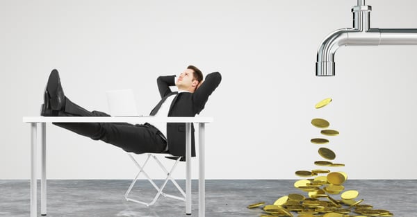 Man relaxing on a chair while money comes out of faucet