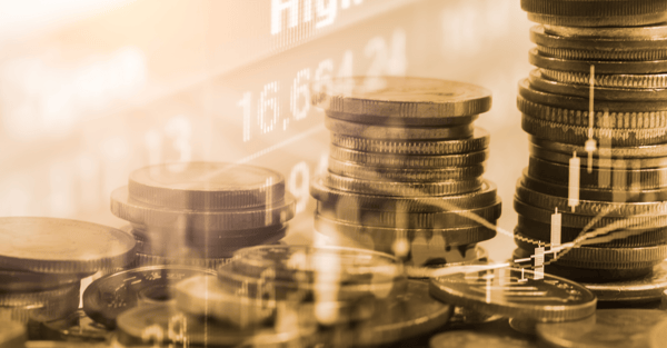 Stack of coins with the forex trading graph on the background